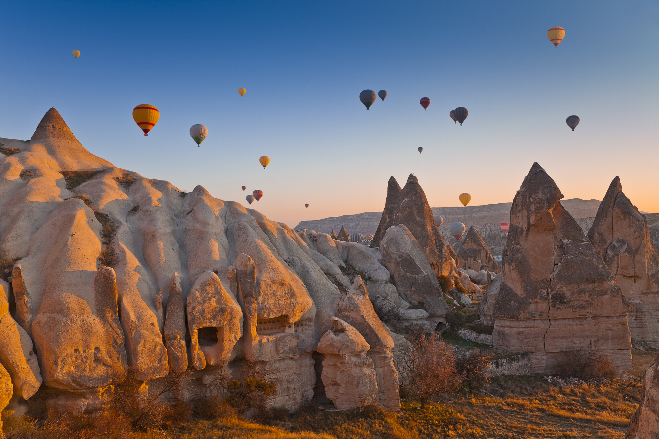 Hot Air Balloons rise up over the Goreme Valley in Cappadocia, Turkey