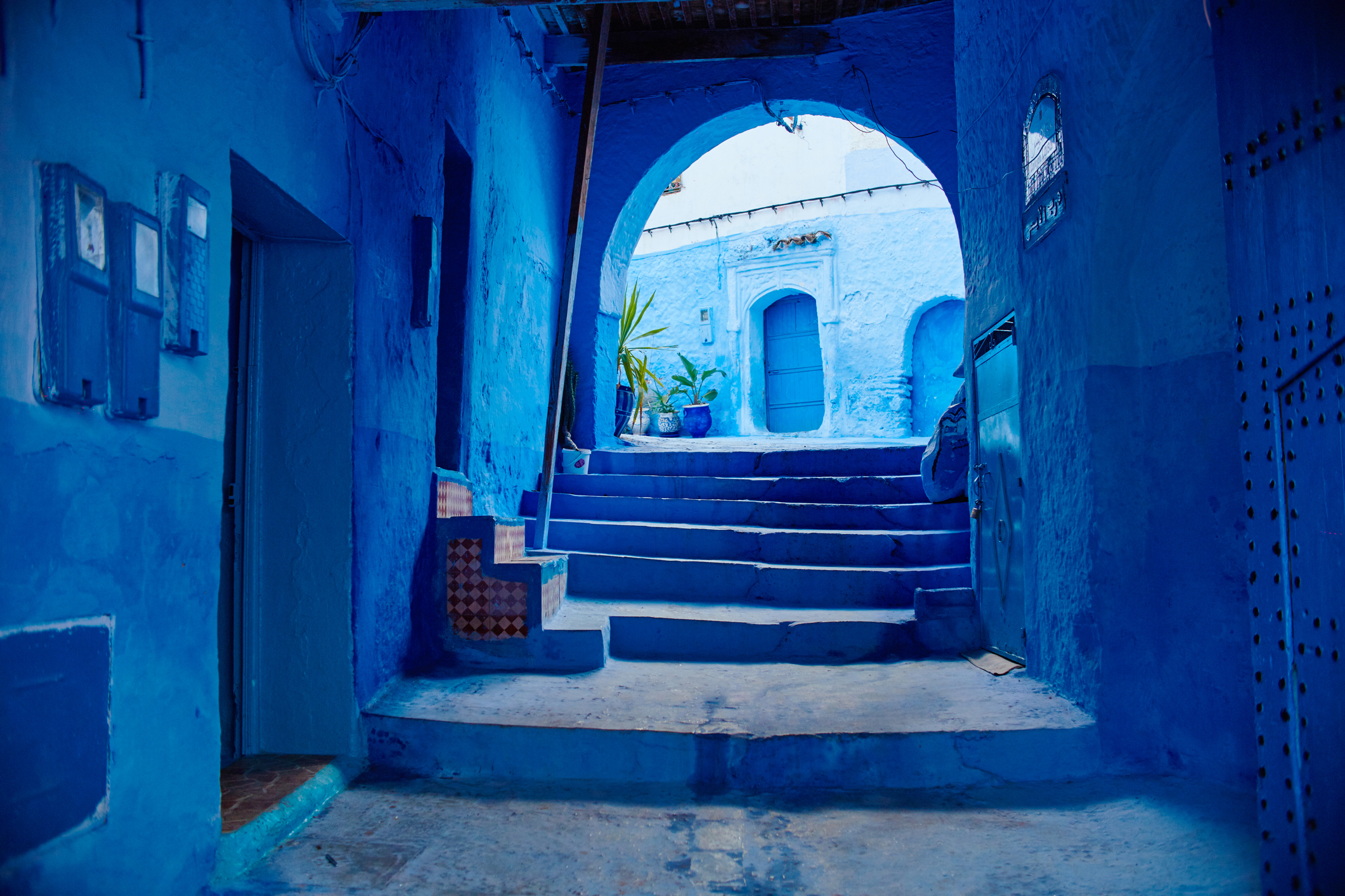 945123938 Morocco is the blue city of Chefchaouen, endless streets painted in blue color. Lots of flowers and Souvenirs in the beautiful streets of Chefchaouen. A magical fairy-tale city of heavenly color